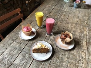 Beetroot latte, tumeric latte, vegan chocolate muffin, vegan raspberry muffin, vegan carrot and coconut cake at W6 Garden Centre Cafe in West London