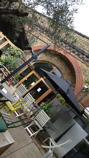 Outdoor space under the arches at W6 Garden Centre Cafe in West London