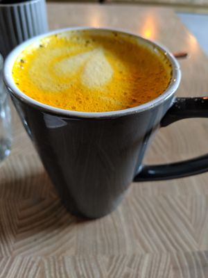 turmeric latte with oat milk at W6 Garden Centre Cafe in West London