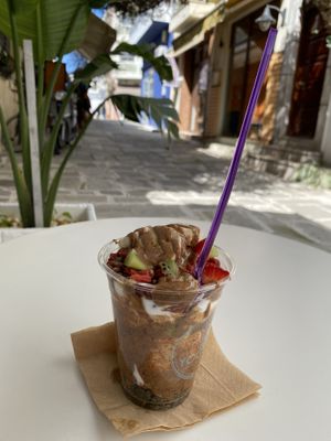 Coconut yogurt with agave syrup, almond butter, goji berries, pumpkin seeds, chocolate chips and fresh fruit   at Fresh Yogurt & More in Kos