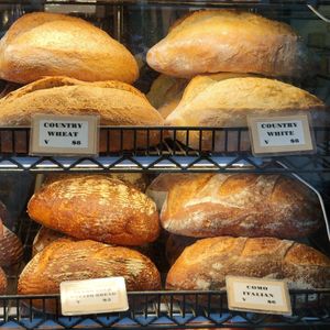 Clearly labeled loaves, easy to tell which have honey or dairy. at Three Girls Bakery in Seattle