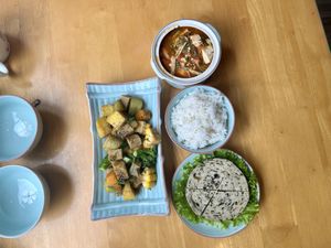 Three dishes and rice   at Achi Vegan House in Hanoi