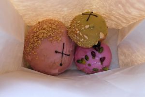 Strawberry and english sparkling Rosé (big one), pomegranate and orange blossom and sour cherry and pistachio - all vegan at Crosstown Doughnuts - Victoria in London