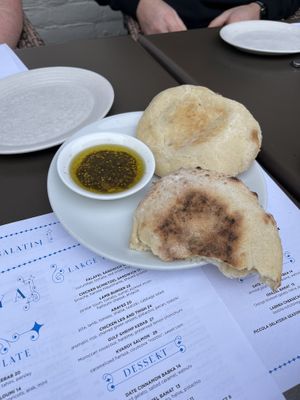 Pita and olive oil given At the beginning is vegan and cooked on site in a stone oven  at Shaya Restaurant in New Orleans