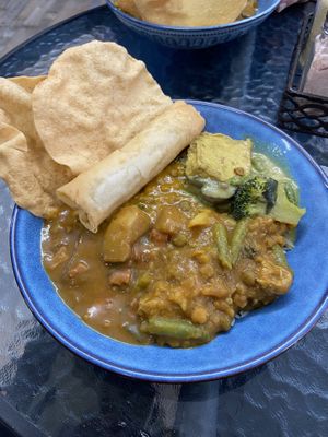 All 4 dishes (Dahl, tofu curry, vgn beef + vgn chicken) plus spring roll 😇  at Great Nature Vegetarian Snacks and Grocery in Christies Beach