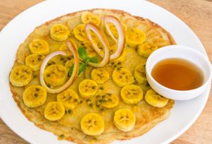 Vegan Banana Passion Pancakes 
Pancakes made of plain flour, coconut milk, vanilla flavored, baking soda.
Top with fresh banana and passion and served with maple syrup   at Footprint Cafes in Siem Reap
