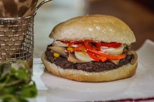 "Ta vivo Maluco" Black bean burger, mushrooms, corn and scallions sauté, heart of palm, red bell pepper, vegan mayo at Neyenmapu Vegan Bistro in Santiago