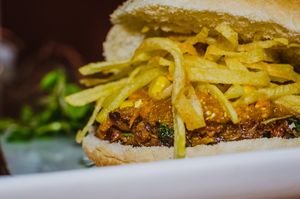 Cochayuyo & veggies burger, squash puré, corn, shoestring potatoes at Neyenmapu Vegan Bistro in Santiago
