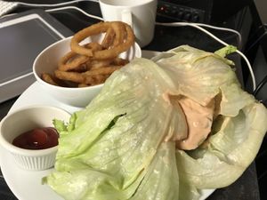 Brocoli Burger on a lettuce wrap w/ onion rings at Parka Food Co. in Toronto