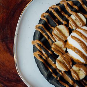 Vegan waffle with activated charcoal, banana, vegan ice cream and almond butter. at The Green Place in Puerto Vallarta