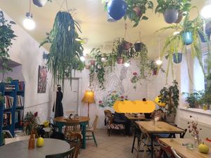 The café from the inside (with a baguette over some strangers' faces for privacy) at Geranium Caffe in Poznan