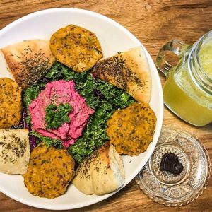 One of our lunch specials; 
Falafel bowl with tahini kale and cabbage slaw, beetroot hummus and toasted herb pita. 
With a glass of homemade Kefir and a chocolate truffle for dessert.  at Mandala Cafe in Puerto Viejo De Talamanca