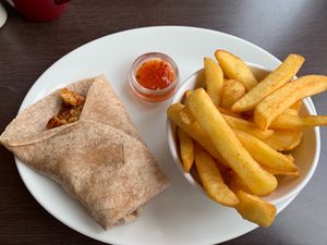 Chickenless chicken sweet chilli wrap and salt and pepper chips. The wrap tastes lovely; chips were stunning. at Phoenix Plant Based Eatery in Prescot