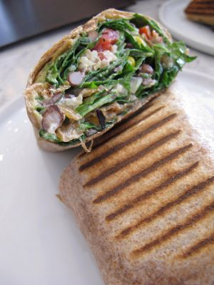 Early riser breakfast wrap. The whole wheat tortilla was filled with quinoa, black beans, corn, pulled portobello mushrooms, spinach, caramelized onions, red pepper, tomato, bragg seasoning, mayo, and again delicious cashew cheese. at Fruitive - Colley Ave in Norfolk
