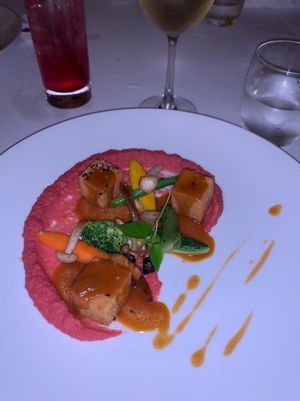 Chickpea cakes on a beet hummus with fresh blanched veggies topped with a AMAZINGLY TASTY sauce  at The Pepper Tree in Phu Quoc