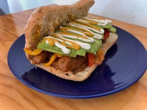 Choripan Sandwich, Vegan chori chori with sweet peppers and avocado, served with roasted potatoes at Cali Cafe in Cozumel