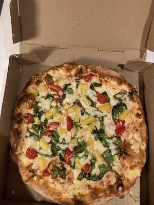 Vegan cheese with tomatoes, spinach and pineapplee  at Pizzolis in Washington
