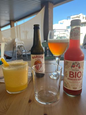 Fresh orange juice with a pasta straw! Red orange soda and a beer  at Happy Cactus in Fuerteventura