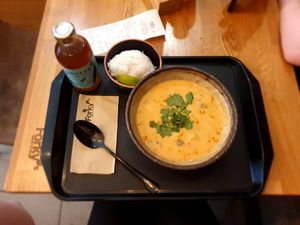 Spicy Thai curry with rice. The bottle contains cool green tea. at Forky's - Veleslavinova in Prague