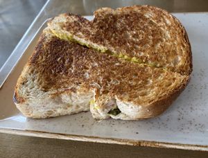 Grilled Cheese with pickles and tomato inside   at The Moth Cafe - Downtown in Edmonton