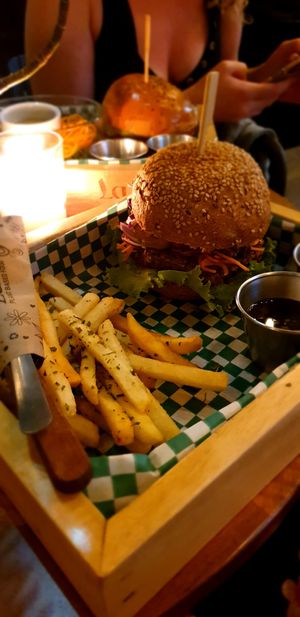 Grain bun, fries on the side. at La Bruja Vegan Foods in Antigua