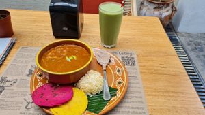 Traditional Pepian dish and golden green smoothie at La Bruja Vegan Foods in Antigua
