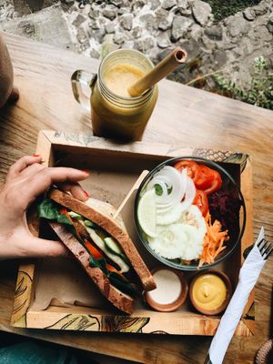 Vegan burger with eggplants steak, fresh garniture , homemade salade and tasty juice at La Bruja Vegan Foods in Antigua