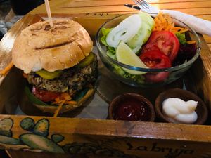 Vegan burger with ketchup and vegan mayo. Salad as a side at La Bruja Vegan Foods in Antigua