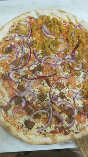 Half tempeh Facon with red onions and tomatoes, half buffalo seitan fajita with red onion and tomato  at Pizza Mia in New Windsor