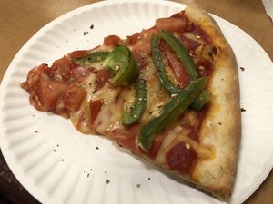 Slice of pizza with tomatoes and peppers at Pizza Mia in New Windsor