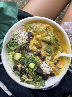 The Mix & Mingle bowl (vegan), half Asian-inspired salad with delicious tempeh, half sweet potato curry  at Stewart & Sally in Amsterdam