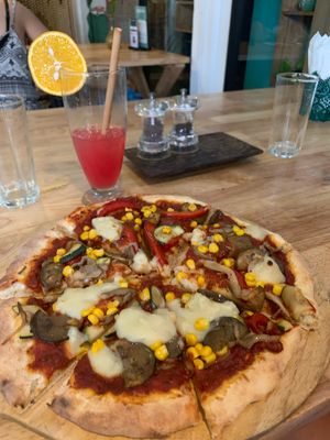 The vegetale pizza and a Cinderella mocktail  at Green-Go Garden in Siem Reap