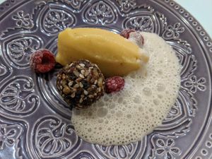 Coconut lemongrass foam, passionfruit banana gelato, and raw chocolate and nut ball. at Cafe Libre in Cuenca