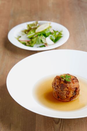 Only available here. Yamato Canederli, giant croquette mix of brown rice, bread and all sorts of vegetables, soaked in our special soup, the vegetable broth with Japanese wild herbs. One of a kind! Come with side dish. at Reset in Tokyo