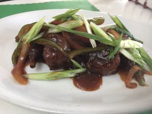 BBQ wings— sauce was a little sweet but the scallions, peppers, and onions were really good accompaniments. This wings are that good seitan quality that tears apart. at MeHungry in Plantation