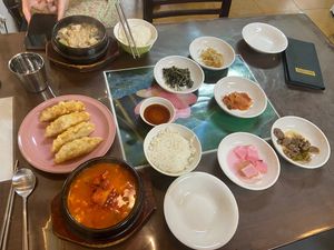 Top left: miso soup. Middle left: kimchi mandu. Bottom left: spicy tofu stew. On the right: side dishes    at Oh Se Gae Hyang - 오세계향 in Seoul