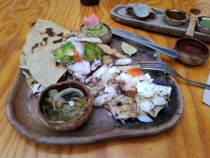 Tlayuda: special corn tortilla, black beans, tomatoes, avocado, lettuce at Hierba Dulce in Oaxaca