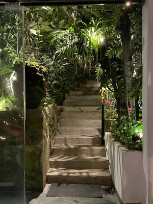 Staircase leading to outdoor garden at Cafe Des Artistes in Puerto Vallarta