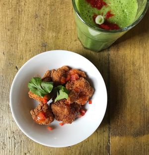Tasty Cauliflower ‘Buffalo Wings’ with the Vegan Thunder Smoothie (Spinach, Kale, Pineapple, Banana, Ginger Lime, Apple Juice & a sprinkling of paprika) Not pictured - the Vegan mayo that accompanies the wings!  at Seeds for the Soul in Edinburgh