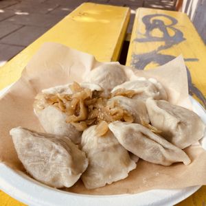 Vegan pierogi topped with onions   at Przystanek Pierogarnia - Bonerowska in Krakow