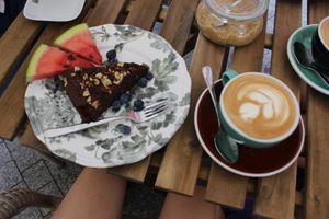 soy cappuccino and vegan brownie with fruit at W Filizance Cafe in Poznan