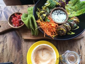 The "Let Us Falafel" salad bowl: sprouted and fried falafels coated in sesame gomashio with marinated aubergine, baby gem salad, house picked onion and red cabbage slaw. Served with tomato salsa, cashew tzatsiki, and grilled toritillas on the side.  at Two Trees Eatery in Tibubeneng