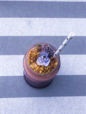 Tropical Fruits Smoothie,
A mix of what was in the BBVegan fridge, it was coconutty, fruity, deliciousness, with a nutty, superfood topping and a cute little edible flower.
 at BBVegan in Chichester