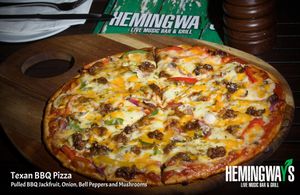 Texan BBQ Pizza
Pulled BBQ Jackfruit, Onion, Bell Peppers and Onions

Choice of Regular Cheese or Daiya Vegan Cheese at Hemingway's By The Bay in Outlying Islands