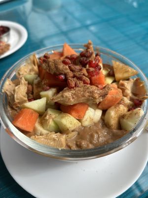 Oatmeal bowl with added fruits and peanut butterr  at Ira's Kitchen & Tea Room in Rishikesh