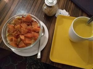 amaranth bowl with fruit topping and tumeric milk at Ira's Kitchen & Tea Room in Rishikesh