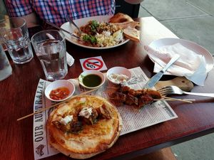chicken skewers in front and chicken curry at back at Cafe Nowa in Petersham