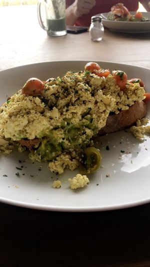 Generous portion of scrambled tofu, avocado and lots of tomatoes- so yum at Crate Cafe in Canggu