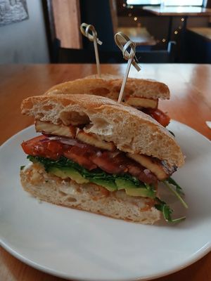 Vegan loaded breakfast sandwich with tofu bacon at Peloton Cafe in Seattle