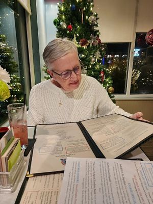 Perusing the menu  at Food For Thought in Williamsburg